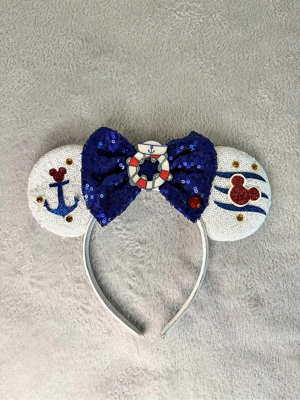 Popeye Cruise Minnie Mouse ears with a blue sequin bow, anchor, and lifebuoy